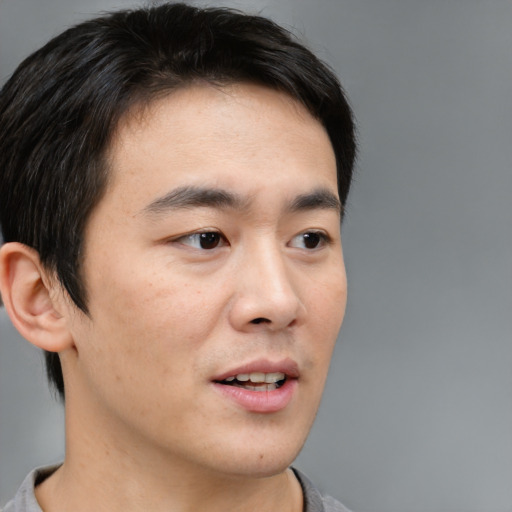 Neutral asian young-adult male with short  brown hair and brown eyes