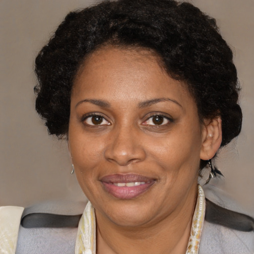 Joyful black adult female with medium  brown hair and brown eyes