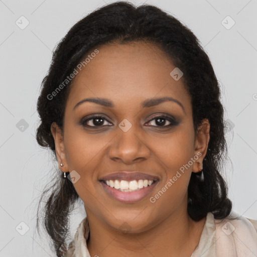 Joyful black young-adult female with long  brown hair and brown eyes