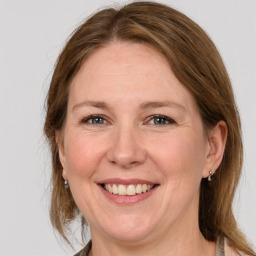 Joyful white adult female with medium  brown hair and grey eyes