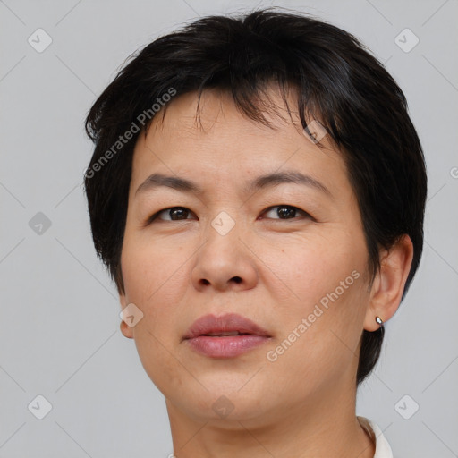 Joyful asian adult female with short  brown hair and brown eyes