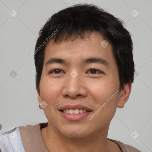 Joyful asian young-adult male with short  brown hair and brown eyes