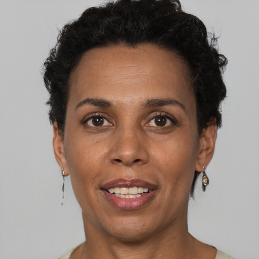 Joyful white adult female with short  black hair and brown eyes