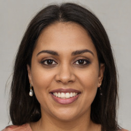 Joyful black young-adult female with medium  brown hair and brown eyes