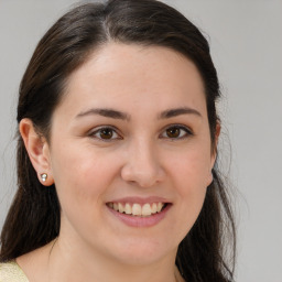 Joyful white young-adult female with medium  brown hair and brown eyes