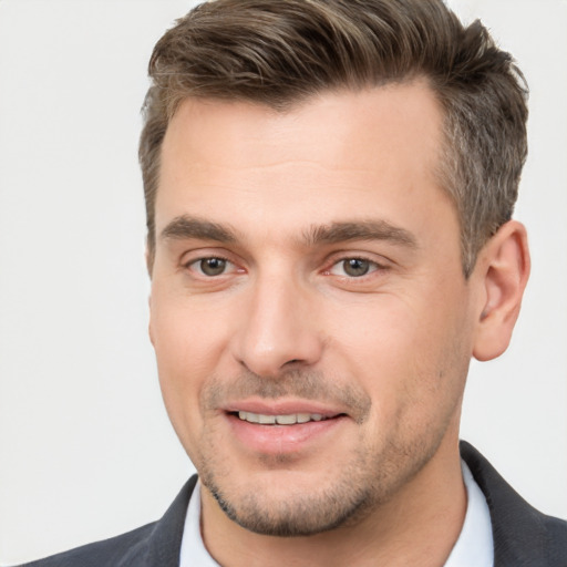 Joyful white young-adult male with short  brown hair and brown eyes