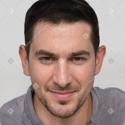 Joyful white adult male with short  brown hair and brown eyes