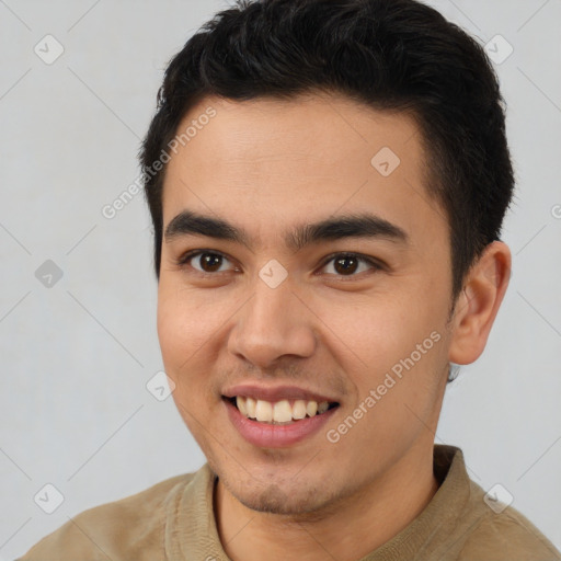 Joyful latino young-adult male with short  brown hair and brown eyes