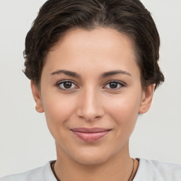 Joyful white young-adult female with short  brown hair and brown eyes