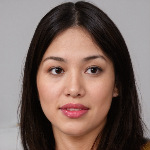 Joyful asian young-adult female with long  brown hair and brown eyes