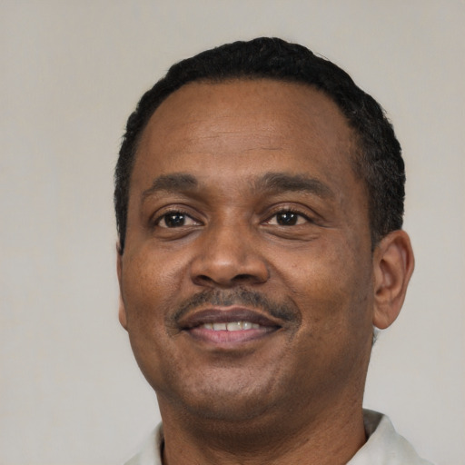 Joyful latino adult male with short  black hair and brown eyes