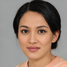 Joyful asian young-adult female with medium  black hair and brown eyes