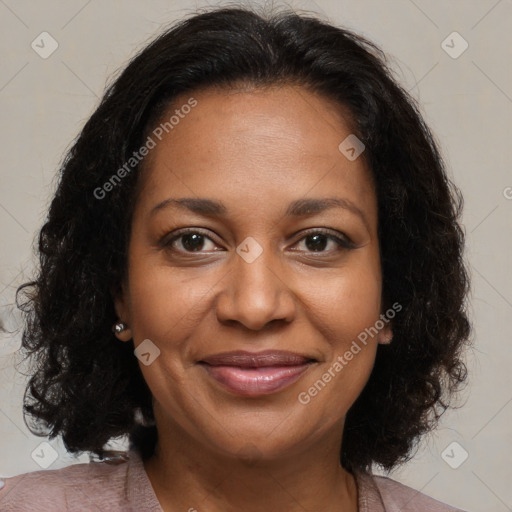 Joyful black adult female with medium  brown hair and brown eyes