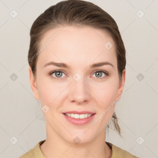 Joyful white young-adult female with medium  brown hair and grey eyes