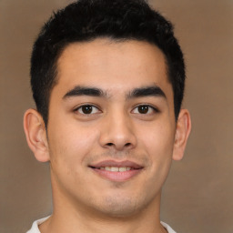 Joyful latino young-adult male with short  brown hair and brown eyes