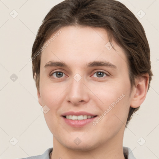 Joyful white young-adult female with short  brown hair and grey eyes