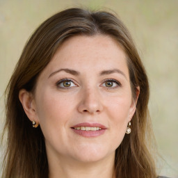 Joyful white young-adult female with long  brown hair and green eyes