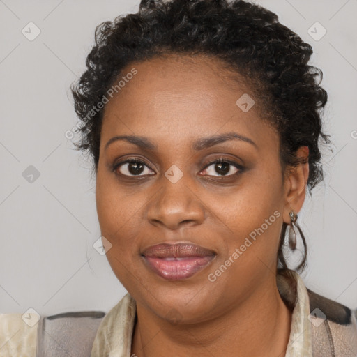 Joyful black adult female with medium  brown hair and brown eyes