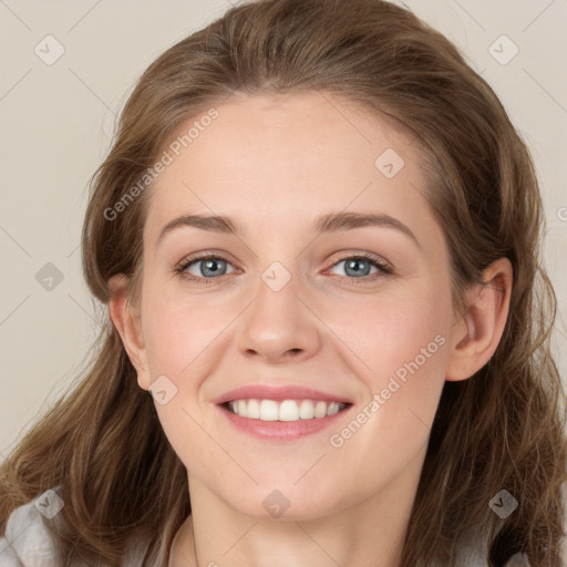 Joyful white young-adult female with long  brown hair and blue eyes