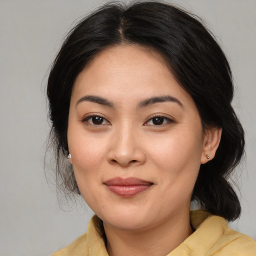 Joyful asian young-adult female with medium  brown hair and brown eyes