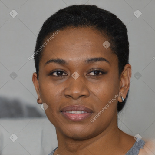 Joyful black young-adult female with short  black hair and brown eyes