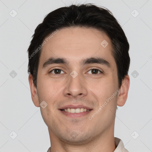 Joyful white young-adult male with short  black hair and brown eyes