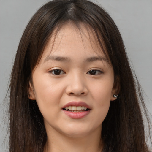Joyful asian young-adult female with long  brown hair and brown eyes