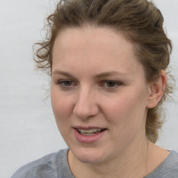 Joyful white young-adult female with medium  brown hair and blue eyes