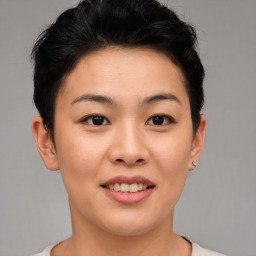 Joyful asian young-adult female with short  brown hair and brown eyes