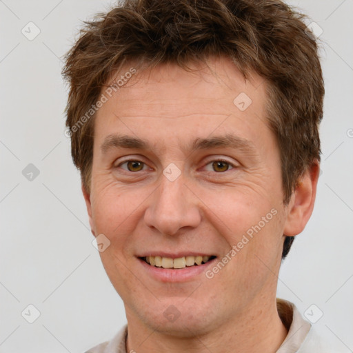 Joyful white adult male with short  brown hair and grey eyes