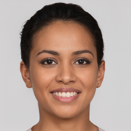 Joyful latino young-adult female with short  brown hair and brown eyes