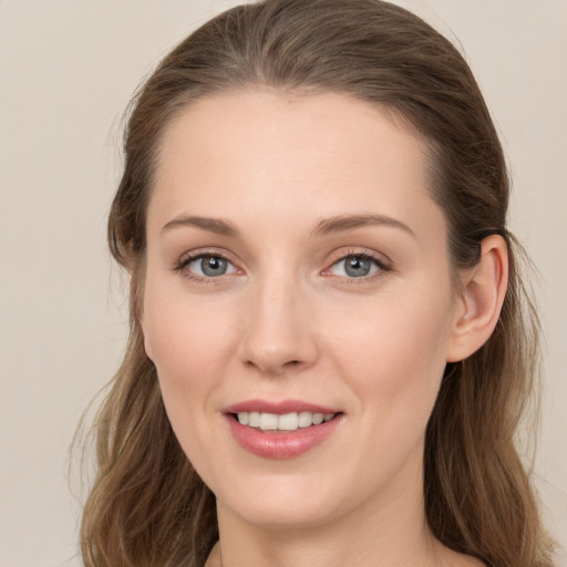 Joyful white young-adult female with long  brown hair and grey eyes