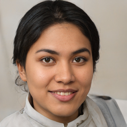 Joyful latino young-adult female with medium  brown hair and brown eyes