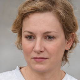 Joyful white adult female with medium  brown hair and blue eyes