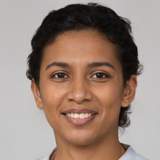 Joyful latino young-adult female with short  brown hair and brown eyes