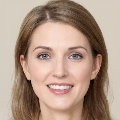 Joyful white young-adult female with long  brown hair and green eyes