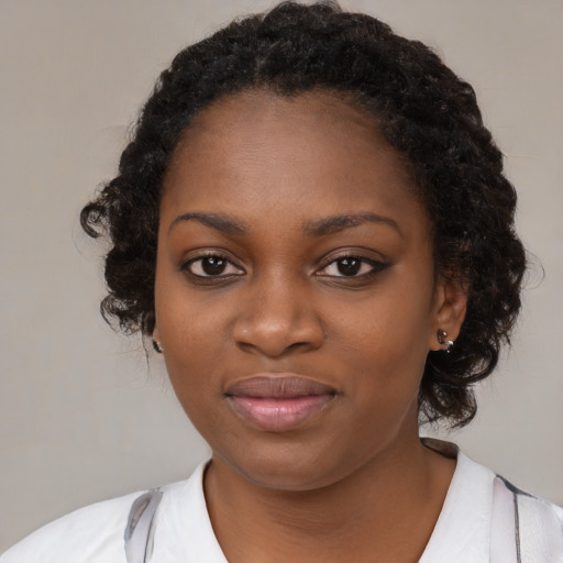 Joyful black young-adult female with medium  black hair and brown eyes