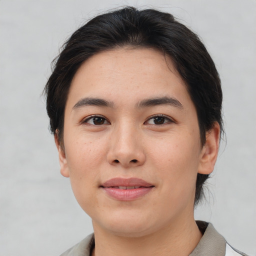 Joyful asian young-adult female with medium  brown hair and brown eyes