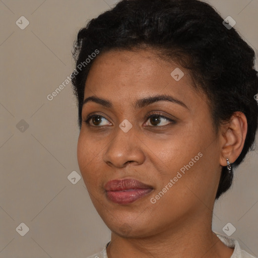 Joyful black young-adult female with short  black hair and brown eyes