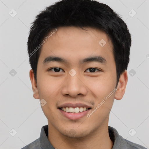 Joyful asian young-adult male with short  black hair and brown eyes