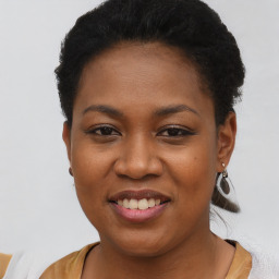 Joyful black young-adult female with short  black hair and brown eyes