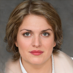 Joyful white young-adult female with medium  brown hair and green eyes