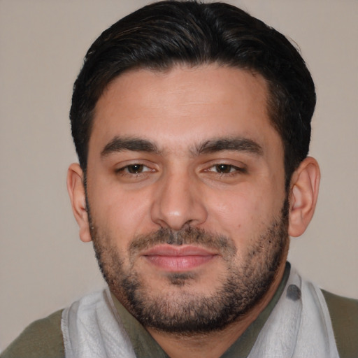 Joyful white young-adult male with short  black hair and brown eyes