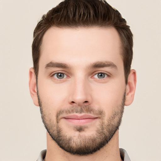 Joyful white young-adult male with short  brown hair and grey eyes