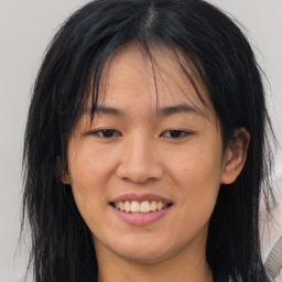 Joyful asian young-adult female with long  brown hair and brown eyes