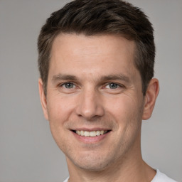 Joyful white adult male with short  brown hair and brown eyes