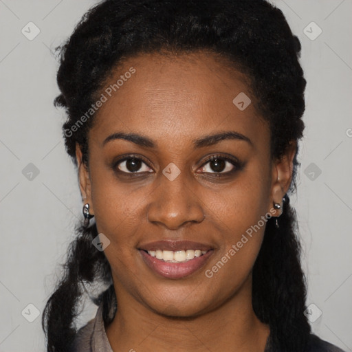 Joyful black young-adult female with long  black hair and brown eyes