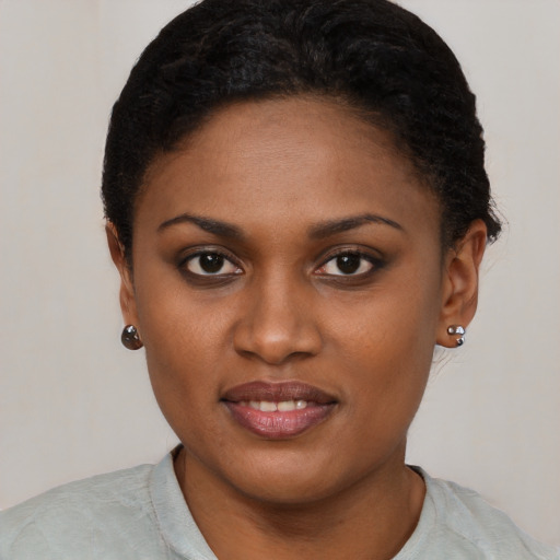 Joyful black young-adult female with short  brown hair and brown eyes