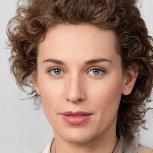 Joyful white young-adult female with medium  brown hair and green eyes