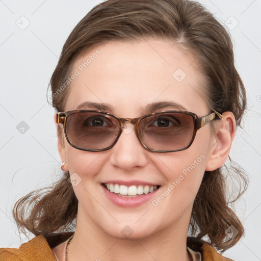 Joyful white young-adult female with medium  brown hair and blue eyes